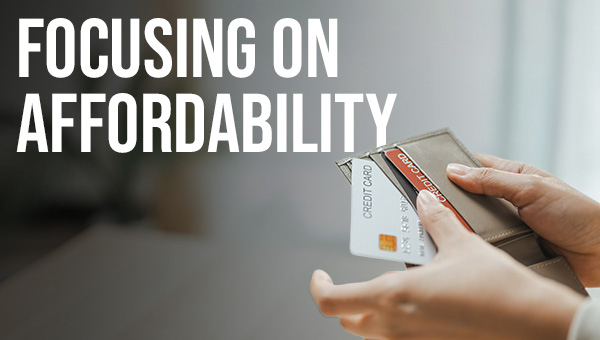 Two hands holding a wallet and removing a credit card, with text reading “Focusing on Affordability.”